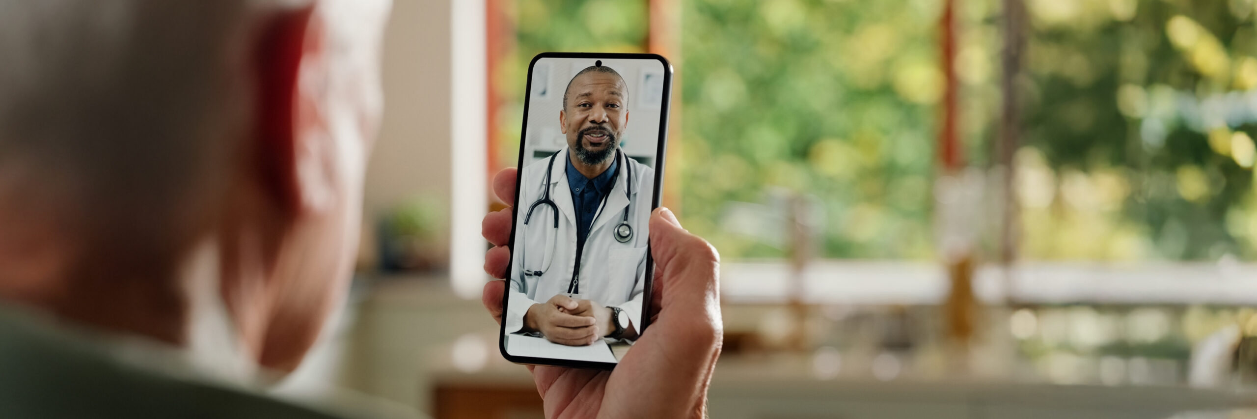 A person video calling a doctor on a smartphone.